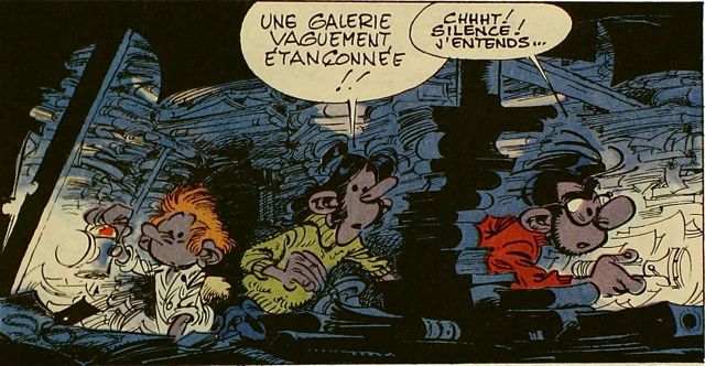 Three guys trudging through a cave made out of books, from Franquin's comic Gaston Lagaffe